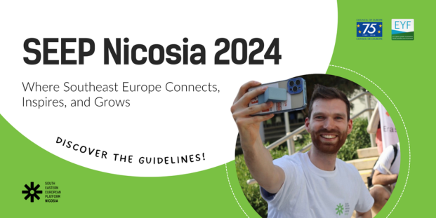 A volunteer holding a phone and ready to do a selfie during the South Eastern European Platform Nicosia 2024 event.