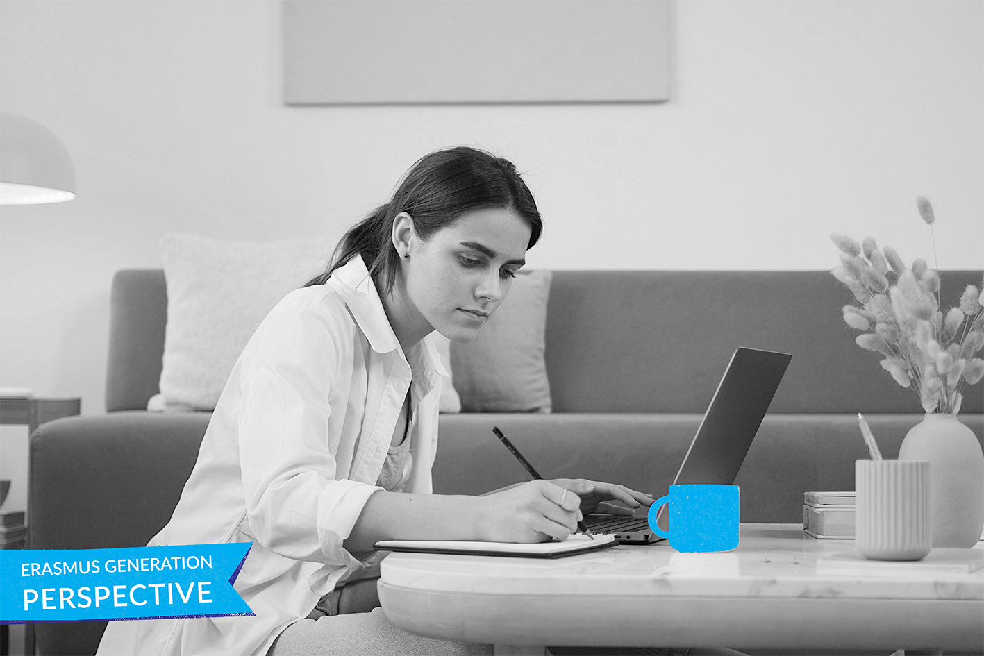 Greyscale photo of person working with a laptop