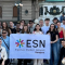 A group of young people posing for a picture with an ESN Sarajevo flag