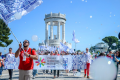 A group of people with colourful flags in front of Pasetto in Ancona, Italy.