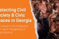 Orange piece of paper on a photo of people with one hand raised. "Protecting Civil Society and Civic Spaces in Georgia. ESN’s reaction to the introduction of the “Law of Transparency of Foreign Influence".